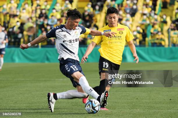 Mao Hosoya of Kashiwa Reysol and Daisuke Suzuki of JEF Unaited Chiba compete for the ball during the preseason friendly match between Kashiwa Reysol...