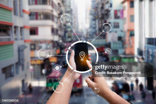 hand holding tablet use ar application to check relevant information. hong kong in marketing street background concept - application programming interface stockfoto's en -beelden