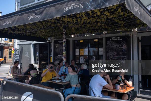 People sit outdoors at a cafe in Newtown on February 12, 2023 in Sydney, Australia. On July 6, 2022 the Australian government lifted all COVID-19...