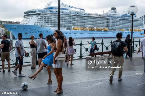 Woman kicks a soccer ball in the harbour with a view of The Royal Caribbean Ovation of The Seas in the background on February 12, 2023 in Sydney,...