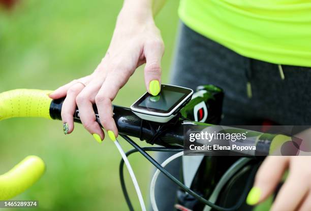 cropped woman' s hands holding bicycle handlebar and taking cardio details - global positioning system stock pictures, royalty-free photos & images