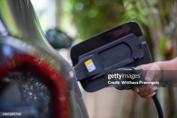 charging battery of an electric car - car battery stock pictures, royalty-free photos & images