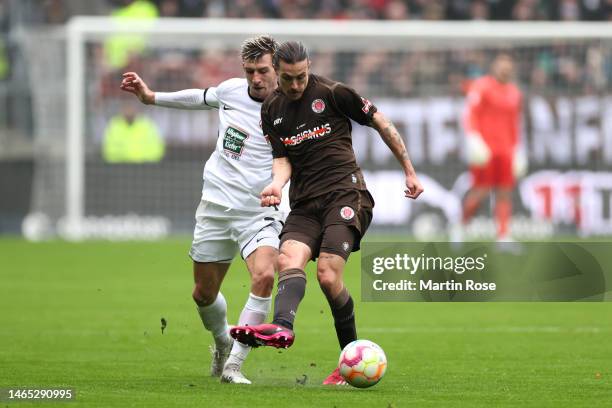 Jackson Irvine of FC St. Pauli passes the ball while under pressure from Daniel Hanslik of 1. FC Kaiserslautern during the Second Bundesliga match...