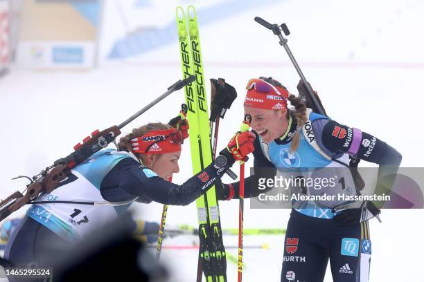 Denise Herrmann-Wick of Germany celebrates with her team mate Hanna Kebinger at the finish area after the Women 10 km Pursuit at the IBU World...