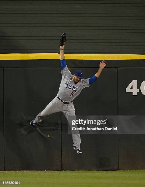 David DeJesus of the Chicago Cubs falls to the ground after trying to catch a home run ball hit by Paul Konerko of the Chicago White Sox in the 6th...