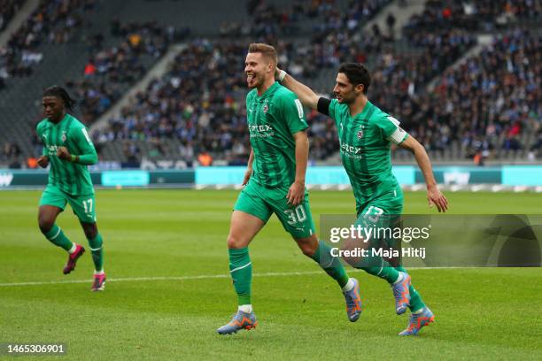 Nico Elvedi of Borussia Monchengladbach celebrates with teammate Lars Stindl after scoring the team's first goal during the Bundesliga match between...