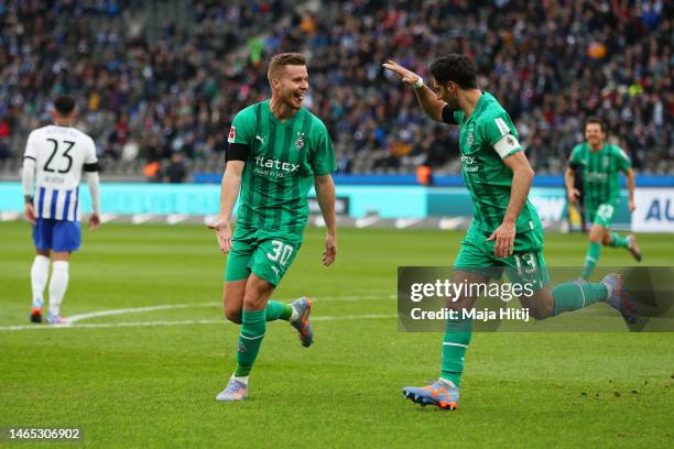 Nico Elvedi of Borussia Monchengladbach celebrates with teammate Lars Stindl after scoring the team's first goal during the Bundesliga match between...