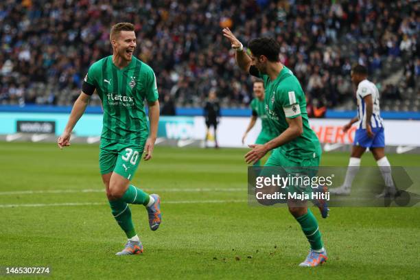 Nico Elvedi of Borussia Monchengladbach celebrates with teammate Lars Stindl after scoring the team's first goal during the Bundesliga match between...