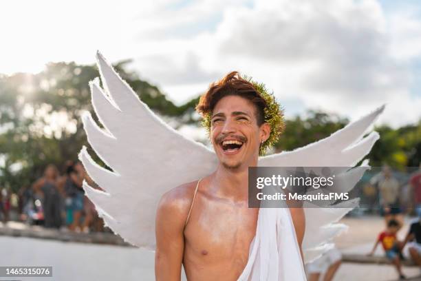 gay man wearing angel costume at carnival in brazil - man angel wings stock pictures, royalty-free photos & images
