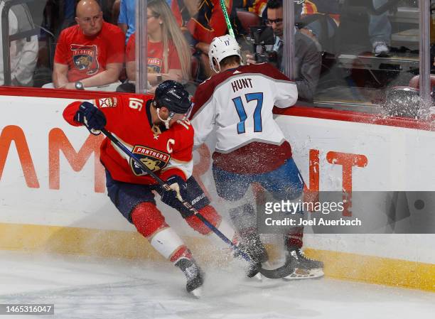 Aleksander Barkov of the Florida Panthers and Brad Hunt of the Colorado Avalanche battle along the boards at the FLA Live Arena on February 11, 2023...