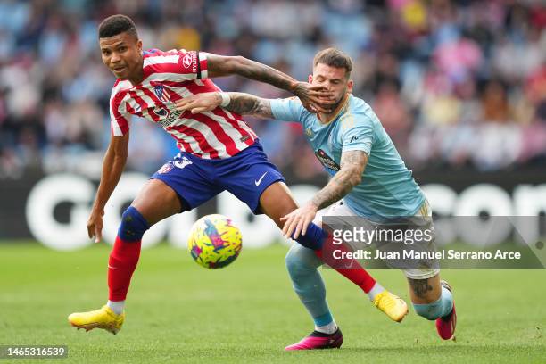 Reinildo Mandava of Atletico Madrid battles for possession with Carles Perez of RC Celta during the LaLiga Santander match between RC Celta and...