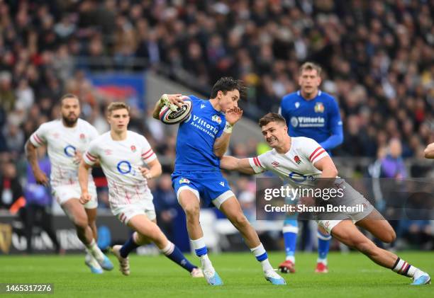 Ange Capuozzo of Italy is tackled by Henry Slade of England during the Six Nations Rugby match between England and Italy at Twickenham Stadium on...