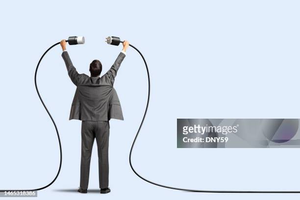 man plugging two power cords together - electrical plug stock pictures, royalty-free photos & images