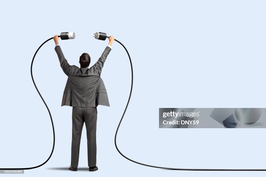 Man Plugging Two Power Cords Together