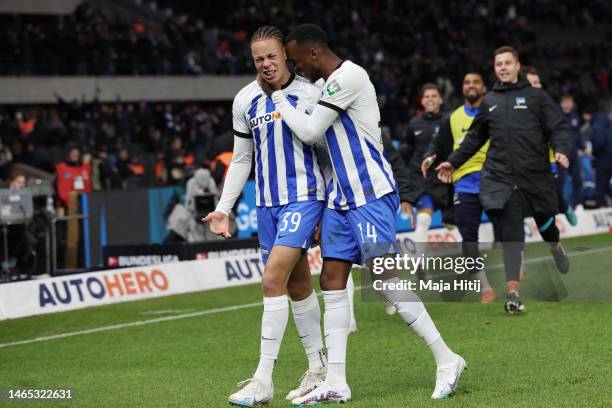 Derry Scherhant of Hertha BSC celebrates with teammate Dodi Lukebakio after scoring the team's third goal during the Bundesliga match between Hertha...