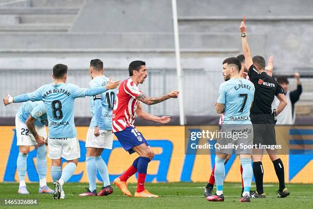 Referee, Jorge Figueroa Vazquez shows a red card to Stefan Savic of Atletico de Madrid during the LaLiga Santander match between RC Celta and...