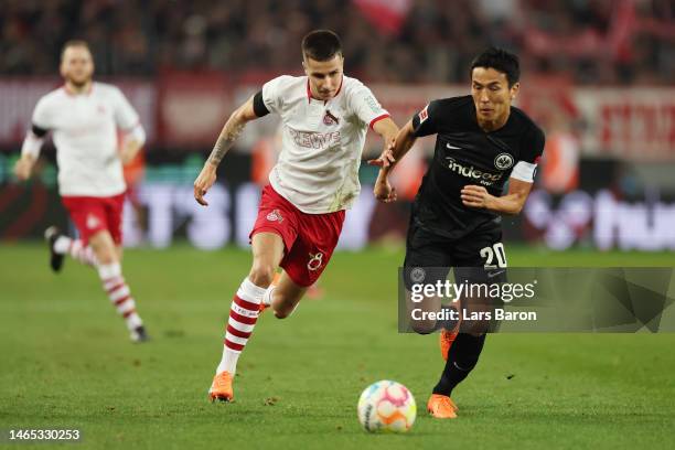 Denis Huseinbasic of 1.FC Koln battles for possession with Makoto Hasebe of Eintracht Frankfurt during the Bundesliga match between 1. FC Koeln and...