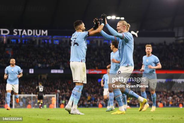 Riyad Mahrez of Manchester City celebrates with team mate Erling Haaland after scoring their sides third goal from the penalty spot during the...