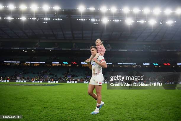 Henry Slade of England walks on the pitch with his daughter following the Six Nations Rugby match between England and Italy at Twickenham Stadium on...