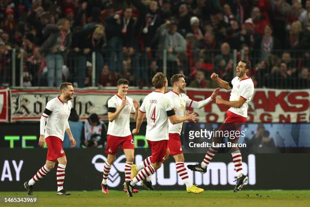 Ellyes Skhiri of 1.FC Koln celebrates with teammates after scoring the team's third goal during the Bundesliga match between 1. FC Koeln and...