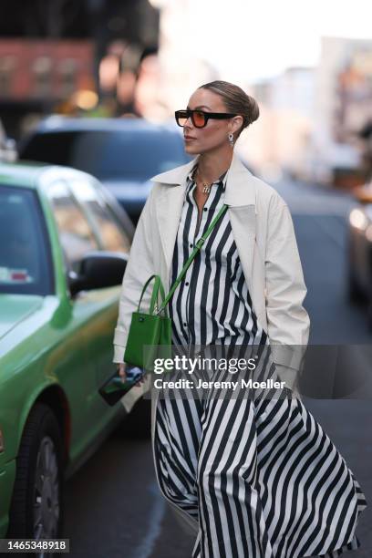 Guest seen wearing black sunglasses with orange lenses, gold necklace, Chanel gold earrings, white and navy blue striped pattern long dress, white...