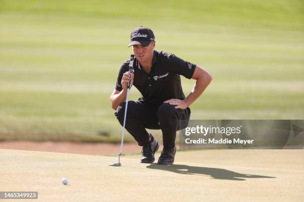 Justin Thomas of the United States lines up a putt on the third green during the final round of the WM Phoenix Open at TPC Scottsdale on February 12,...