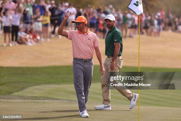 Rickie Fowler of the United States celebrates a hole-in-one on the seventh hole as Jason Day of Australia looks on during the final round of the WM...