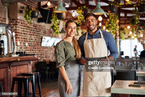 restaurant, portrait and small business owner or team happy and smiling in coffee shop or cafe. entrepreneur, waiter and collaboration with startup by people in partnership with tablet for sales data - small restaurant stock pictures, royalty-free photos & images