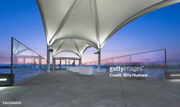 public passenger ferry terminal illuminated by led energy-efficient lights at sunset. - san francisco bay stock pictures, royalty-free photos & images
