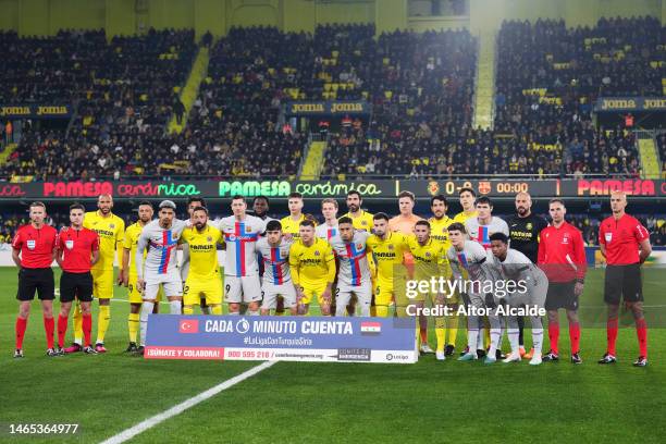 Players of Villarreal CF and FC Barcelona line up on the pitch with match officials prior to the LaLiga Santander match between Villarreal CF and FC...