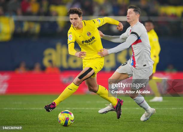 Pau Torres of Villarreal CF battles for possession with Robert Lewandowski of FC Barcelona during the LaLiga Santander match between Villarreal CF...