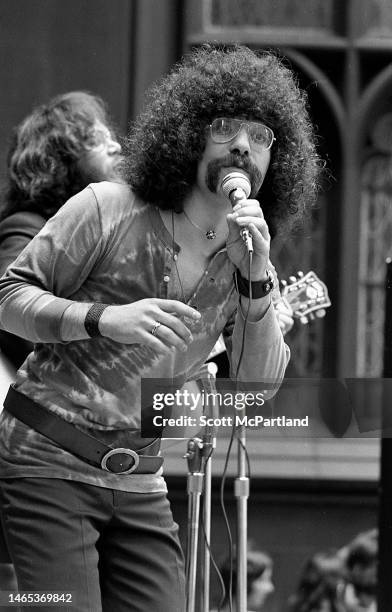 View of two unidentified musicians as they perform outside Trinity Church , New York, New York, June 19, 1970.