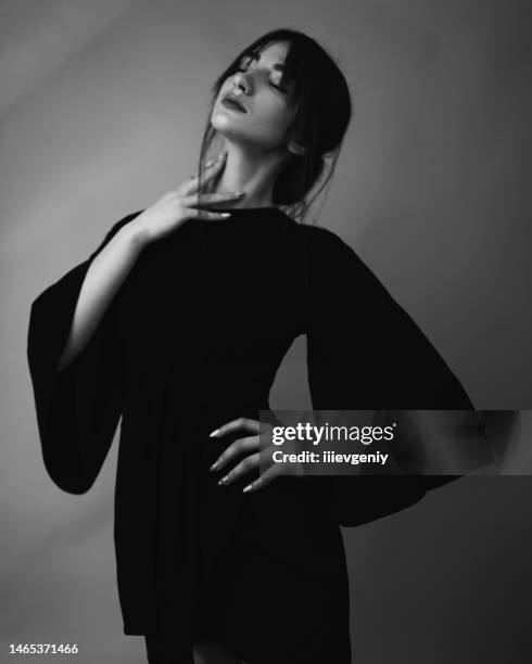 brunette asian woman in black dress in studio - haute couture photos stock pictures, royalty-free photos & images
