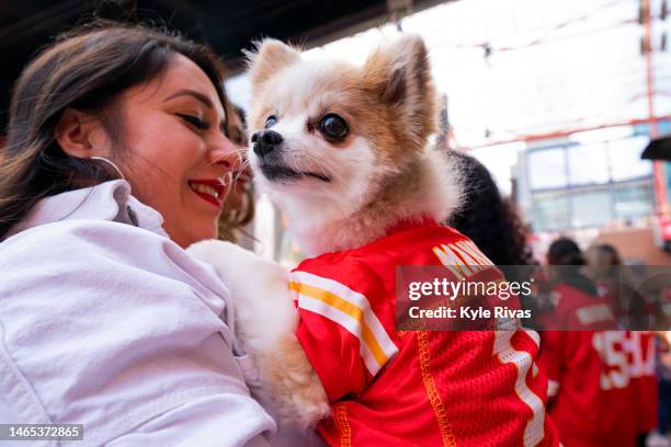 Dog dressed in a Patrick Mahomes jersey and its owner enter the Power and Light Entertainment District as fans prepare to watch the Kansas City...