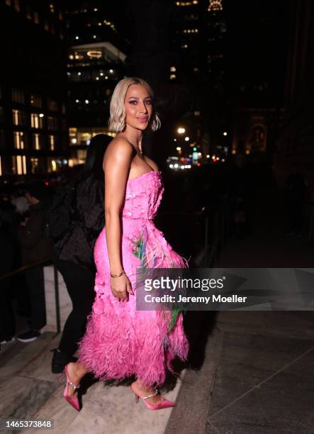 Model Roz is seen wearing a pink off-shoulder flower printed dress, pink matchy high heels outside the Prabal Gurung show during New York Fashion...