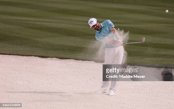 Adam Hadwin of Canada plays a shot from a bunker on the tenth hole during the final round of the WM Phoenix Open at TPC Scottsdale on February 12,...