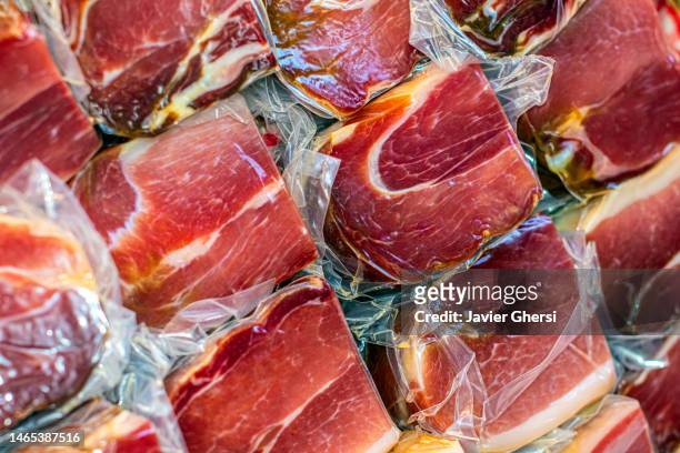 sausage food: raw ham for sale - gezout stockfoto's en -beelden