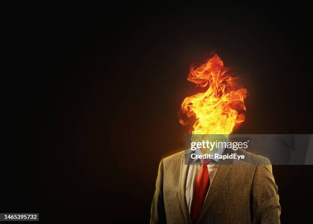 businessman's head bursts in flames, representing emotional stress or even a headache - mental-burnout stock pictures, royalty-free photos & images