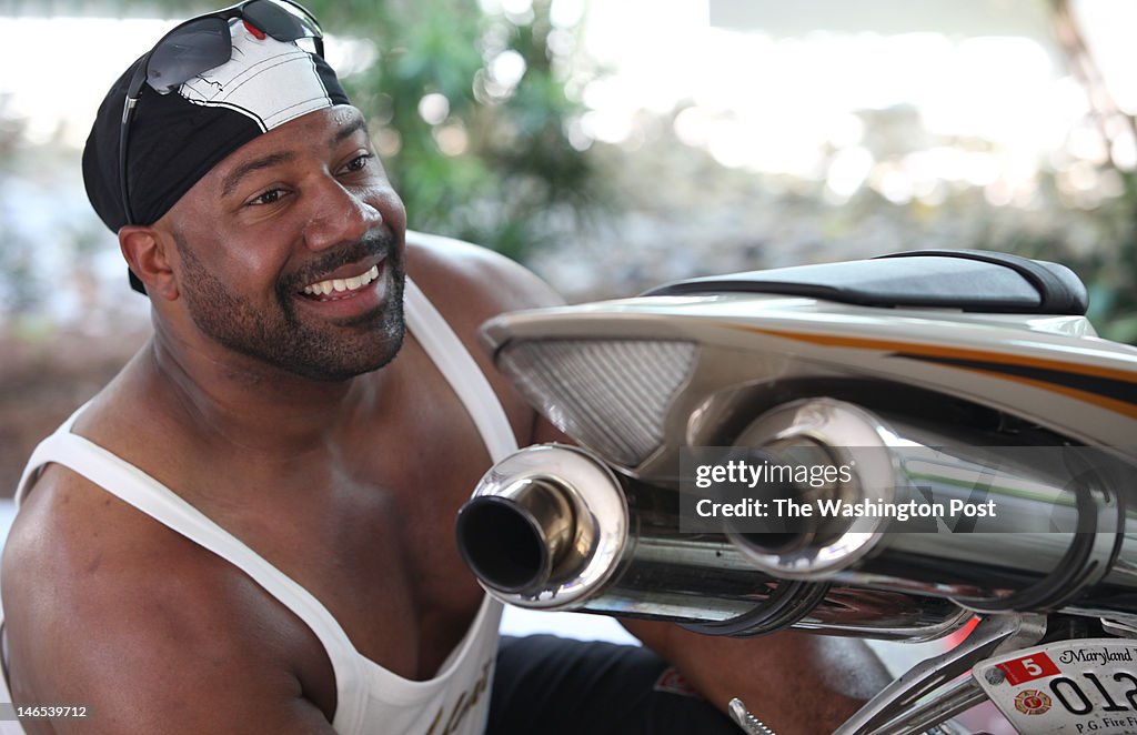 Al Green of Waldorf, Maryland, cleans his bike Thursday in the garage area of a beach rental house in Surfside Beach, South Carolina before going on a ride.