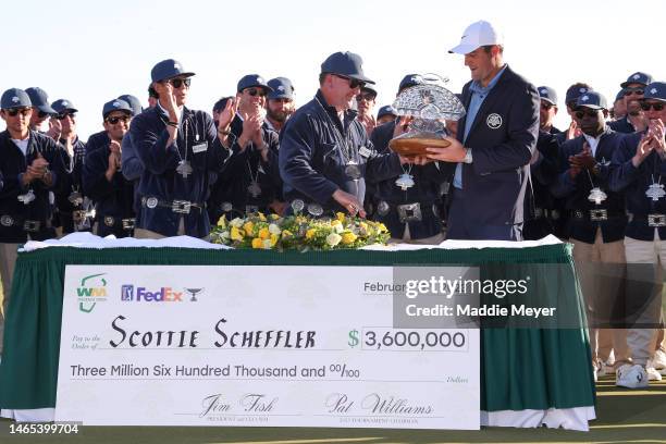 Scottie Scheffler of the United States is awarded the trophy after winning during the final round of the WM Phoenix Open at TPC Scottsdale on...