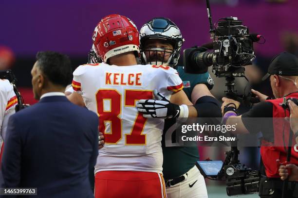 Travis Kelce of the Kansas City Chiefs hugs Jason Kelce of the Philadelphia Eagles before Super Bowl LVII at State Farm Stadium on February 12, 2023...