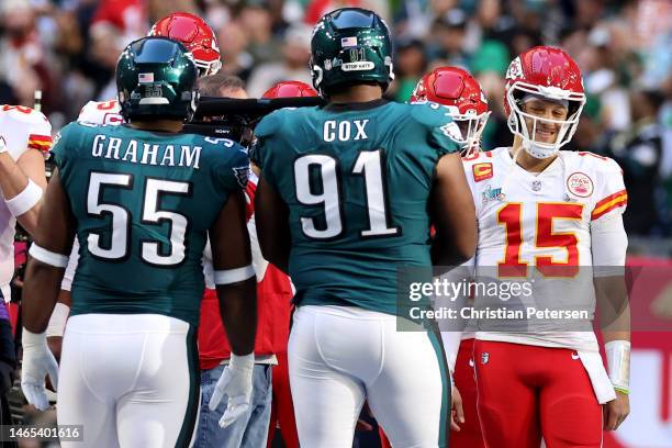 Patrick Mahomes of the Kansas City Chiefs reacts with Brandon Graham of the Philadelphia Eagles and Fletcher Cox of the Philadelphia Eagles during...