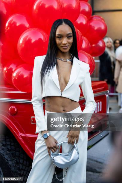 Jourdan Dunn wears white cropped blazer, pants, Audemars Piguet watch, silver bag outside Alice & Olivia during New York Fashion Week on February 11,...