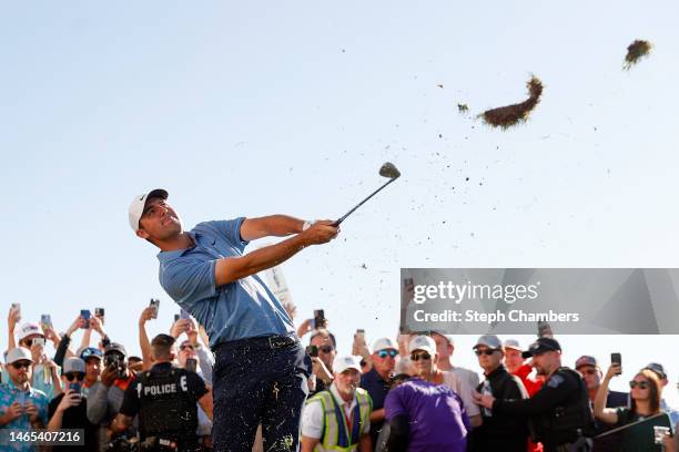 Scottie Scheffler of the United States plays an approach shot on the 18th hole during the final round of the WM Phoenix Open at TPC Scottsdale on...