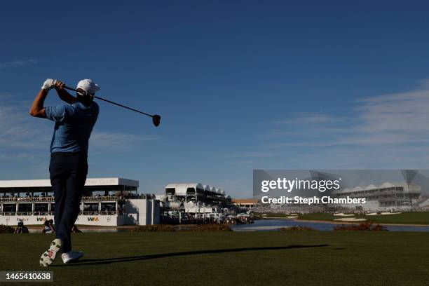 Scottie Scheffler of the United States plays his shot from the 18th tee during the final round of the WM Phoenix Open at TPC Scottsdale on February...