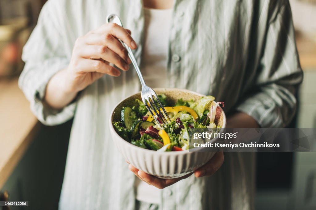 Woman holding bowl with products for heart-healthy diet, closeup