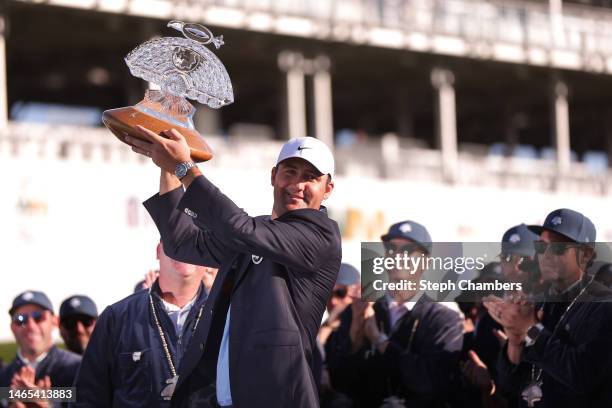 Scottie Scheffler of the United States celebrates with the trophy during the trophy ceremony after the final round of the WM Phoenix Open at TPC...