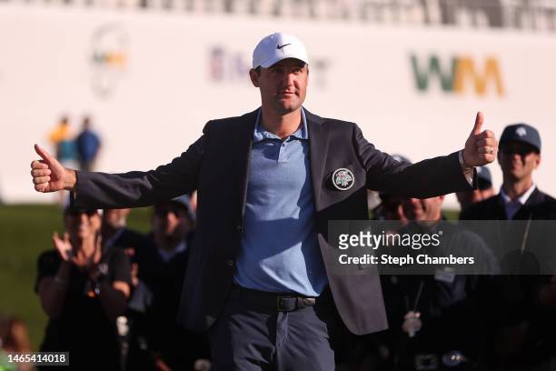 Scottie Scheffler of the United States gives a thumbs up at the trophy ceremony during the final round of the WM Phoenix Open at TPC Scottsdale on...