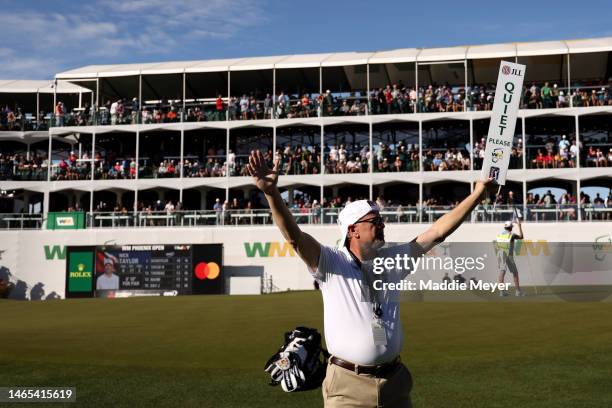 Volunteer holds a "Quiet" paddle on the 16th hole during the final round of the WM Phoenix Open at TPC Scottsdale on February 12, 2023 in Scottsdale,...