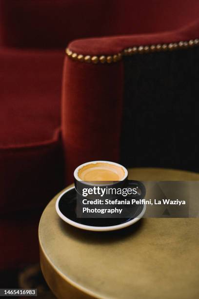 espresso on coffee table with empty armchair - coffee table cafe stock pictures, royalty-free photos & images